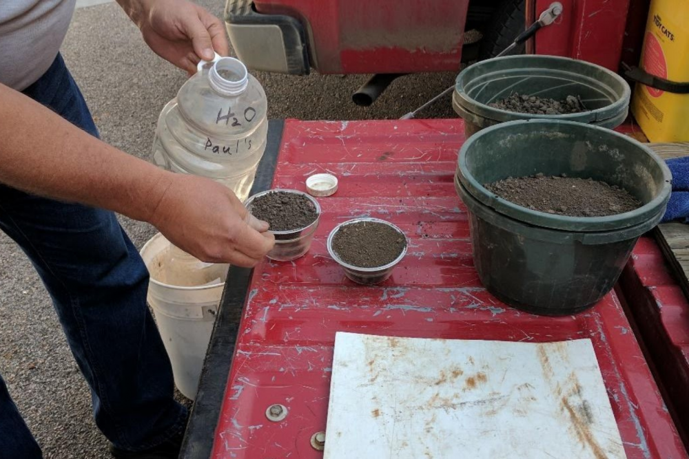 Scientist conducting a soil infiltration test.