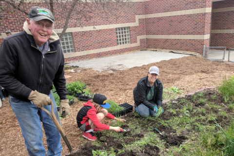 Community volunteers planting a pollinator garden